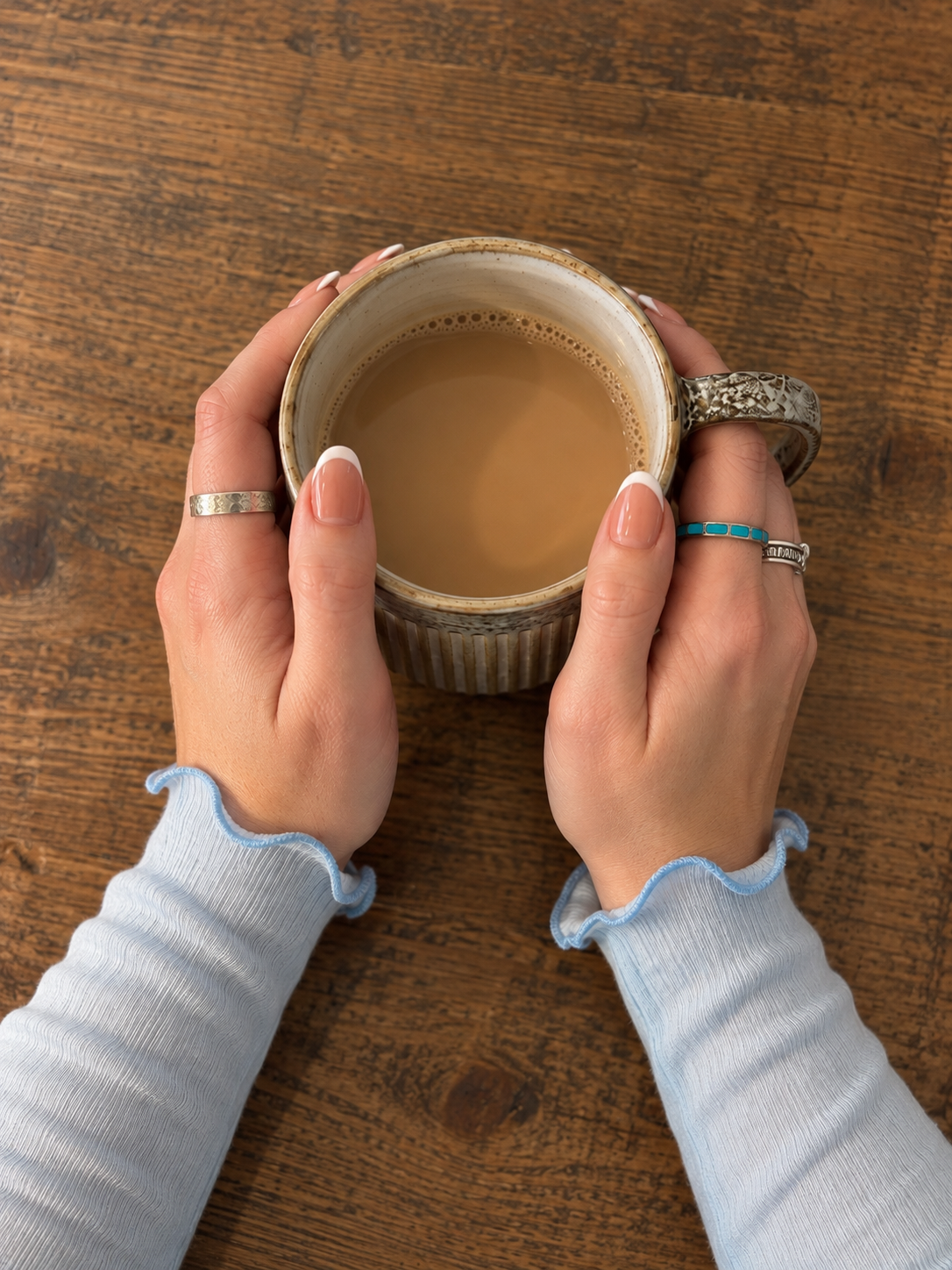 Hands wrapped around a warm mug of coffee